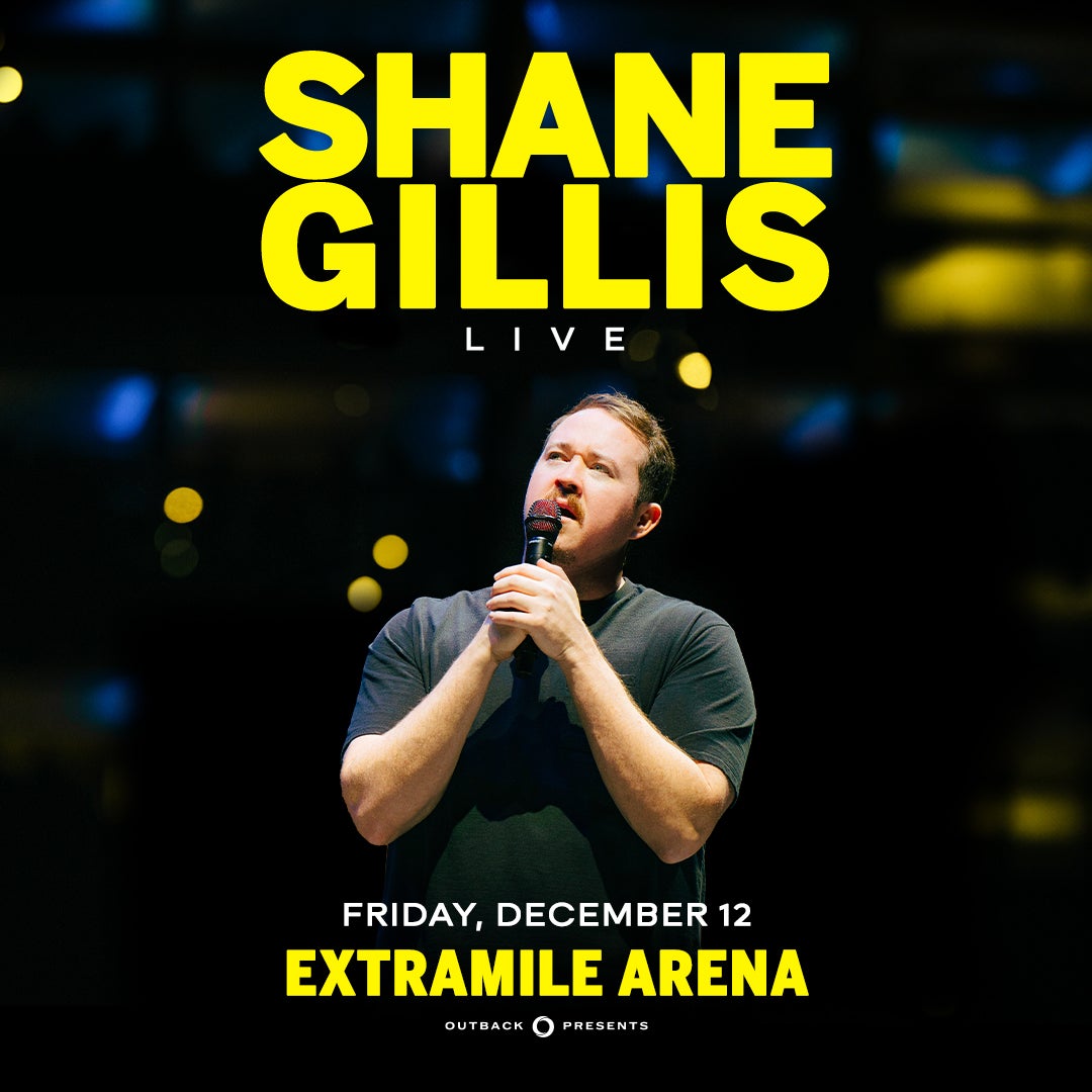 Promotional image for comedian Shane Gillis Live at ExtraMile Arena on Friday, December 12, presented by Outback Presents. The image shows Shane Gillis holding a microphone and looking upward, with bold yellow text on a dark background.