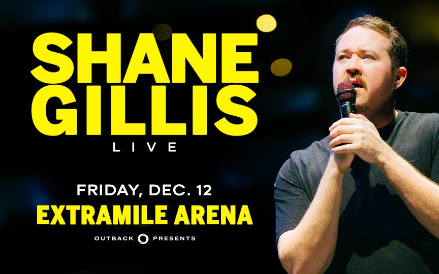 Promotional image for comedian Shane Gillis Live at ExtraMile Arena on Friday, December 12, presented by Outback Presents. The image shows Shane Gillis holding a microphone and looking upward, with bold yellow text on a dark background.